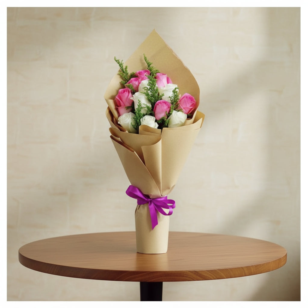 Bouquet of pink and white roses wrapped in brown paper with a purple ribbon on a beige background