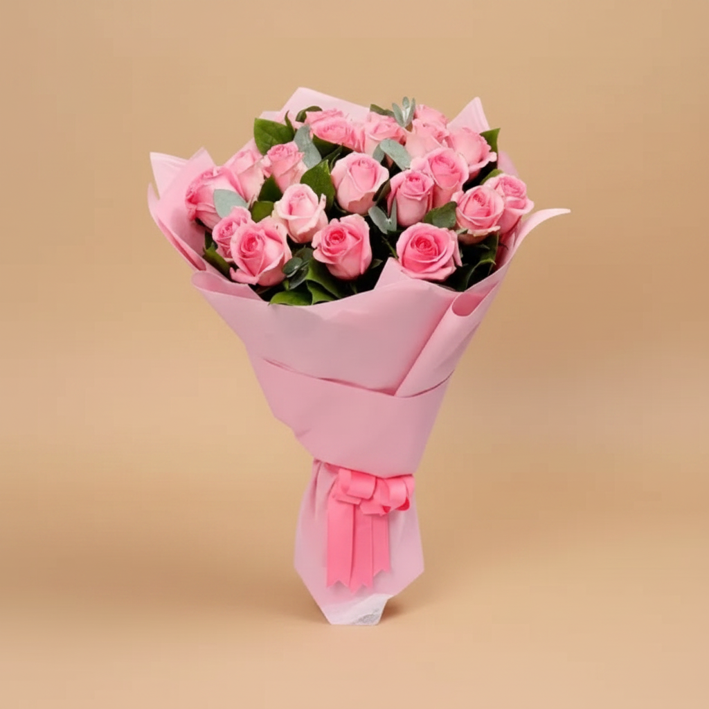 Bouquet of pink roses wrapped in pink paper on a white background