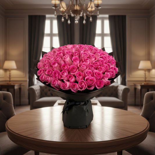Bouquet of pink roses wrapped in black paper on a white background