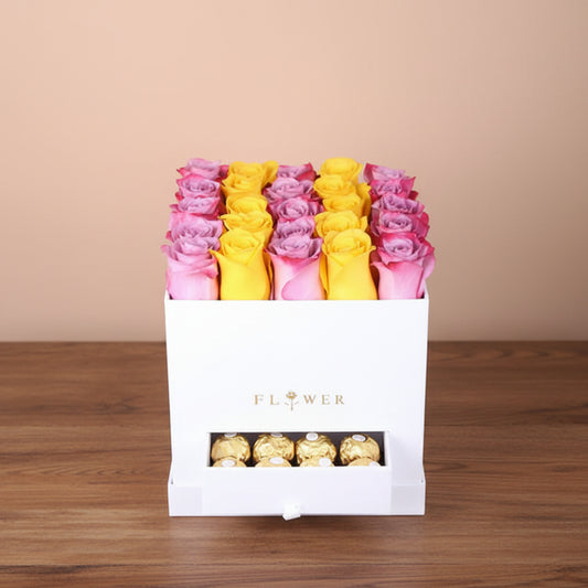 Decorative box with pink and yellow flowers and gold chocolates on a beige background