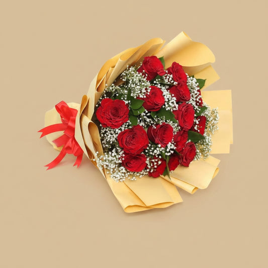 Bouquet of red roses with yellow wrapping paper and a red bow on a white background