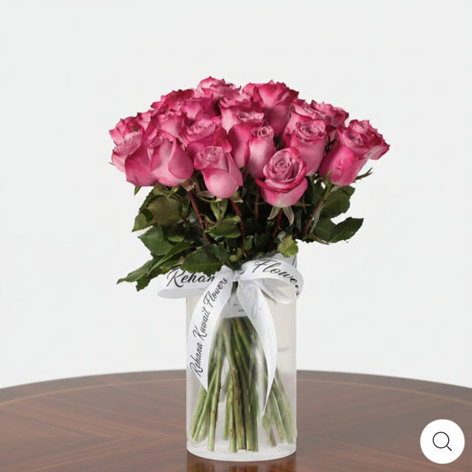 Bouquet of pink roses in a clear vase on a white background