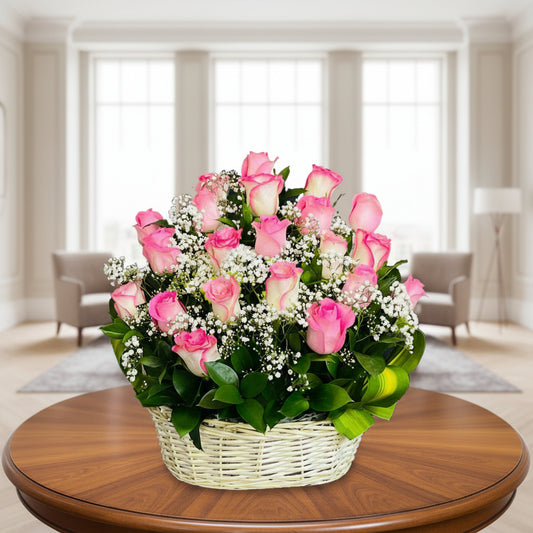 Bouquet of pink and white roses in a wicker basket on a table.