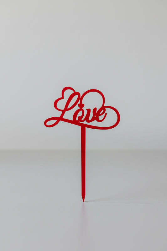 Red 'Love' cake topper on a white background