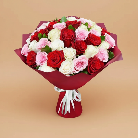 Bouquet of red, white, and pink roses wrapped in red paper on a white background