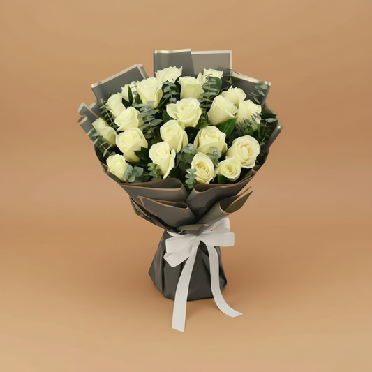 Bouquet of white roses wrapped in black paper with a white ribbon on a white background