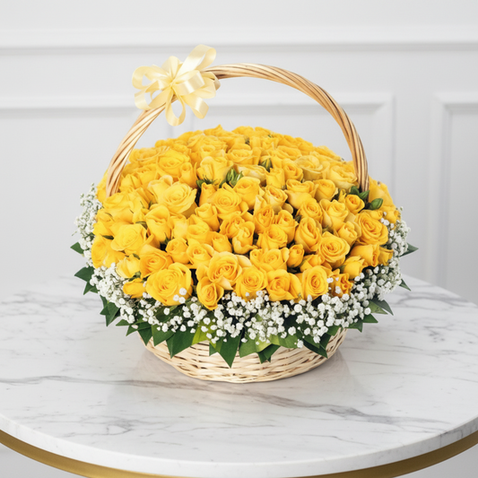 Basket of yellow roses with a decorative bow on a white background