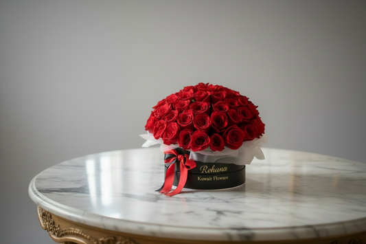 Bouquet of red roses in a black box with a red ribbon on a white background