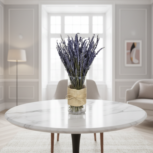 Glass vase with lavender bundle wrapped in burlap on a white background
