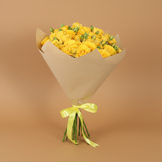 Bouquet of yellow flowers wrapped in brown paper with a green ribbon on a white background