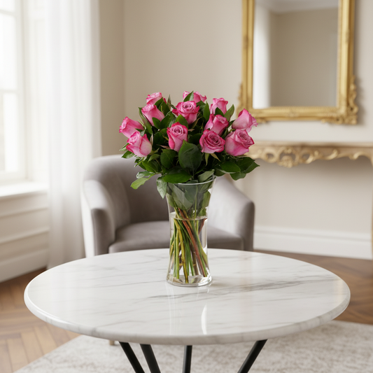 Bouquet of pink roses in a clear vase on a white background