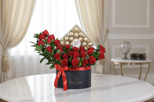 Bouquet of red roses in a box with a red ribbon and a chocolate box on a white background